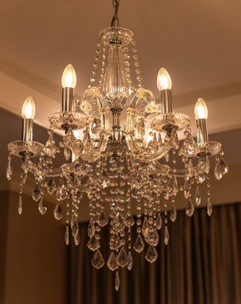 Chrystal chandelier lamp on the ceiling in Dining room Adjusting the image in a Luxury tone .Decorative elegant vintage and Contemporary interior Concept.