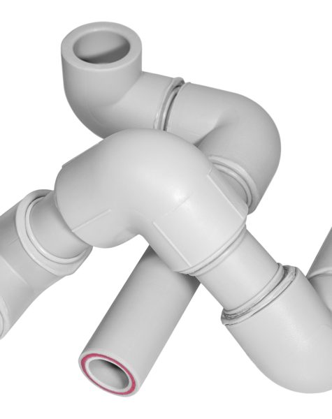 Plumbing polypropylene pipes with fitings on the white background. Building and plumbing accessories